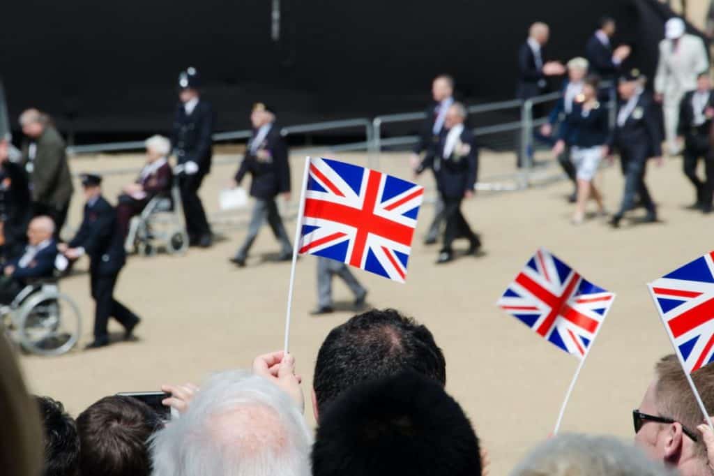 A striking image of British flags at a parade honoring WWII veterans.
